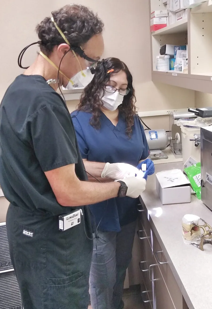 Dr. Neff and a dental assistant preparing for a patient visit