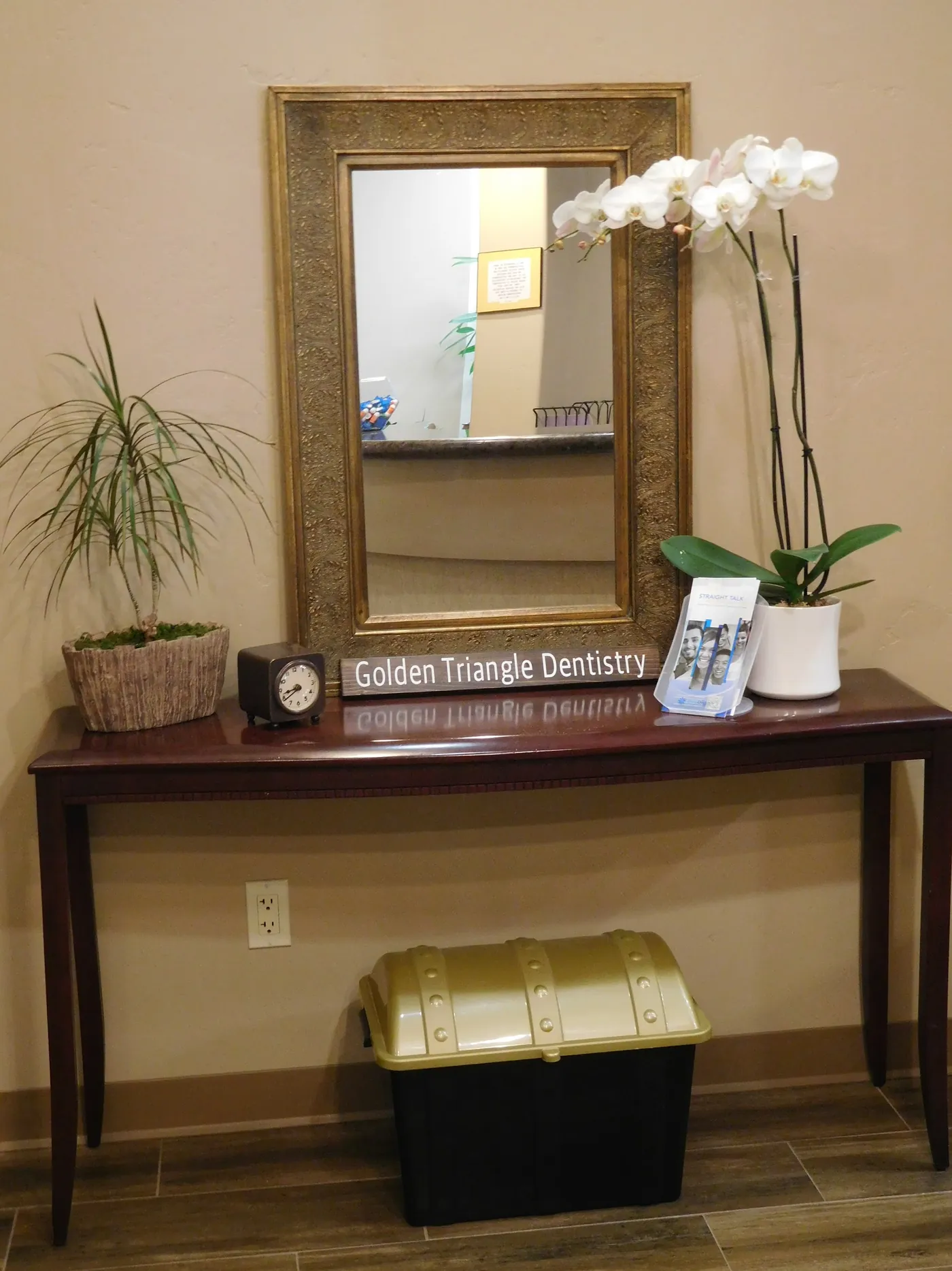 The entry table with the Golden Triangle Dentistry sign