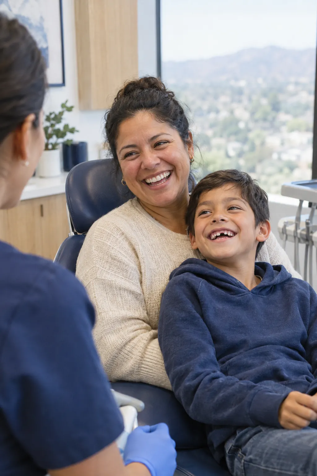 A Murrieta family smiling together in a bright, modern dental office